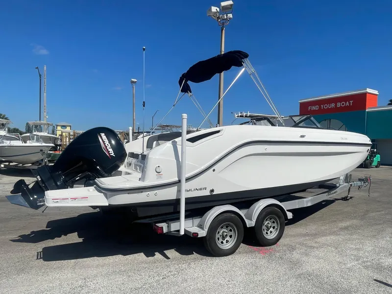 The Image of 2021 Bayliner DX 2200 boat on a trailer with a Mercury outboard motor. - 0