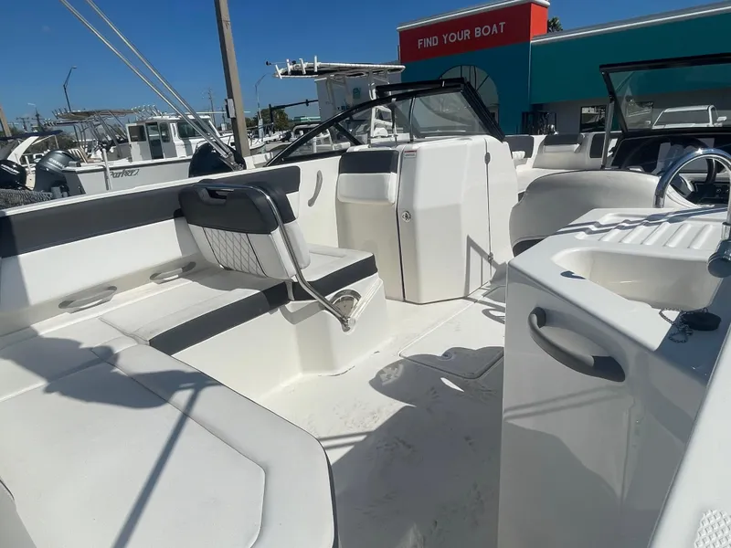 Slide: The Image of 2021 Bayliner DX 2200 boat interior with seating and helm station. - 7