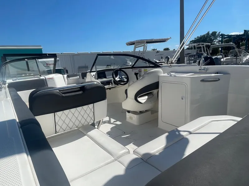 Slide: The Image of 2021 Bayliner DX 2200 boat interior with white and black seating. - 8