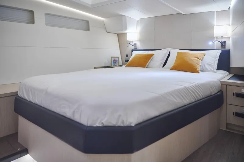 Slide: The Image of Luxurious bedroom interior of 2024 Jeanneau 60 yacht with modern design and cozy bedding. - 25