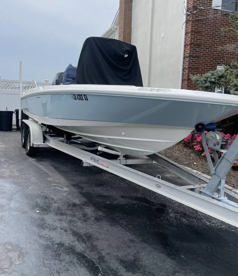 Slide: The Image of 2014 Boston Whaler 210 Dauntless boat on trailer, parked outdoors. - 5