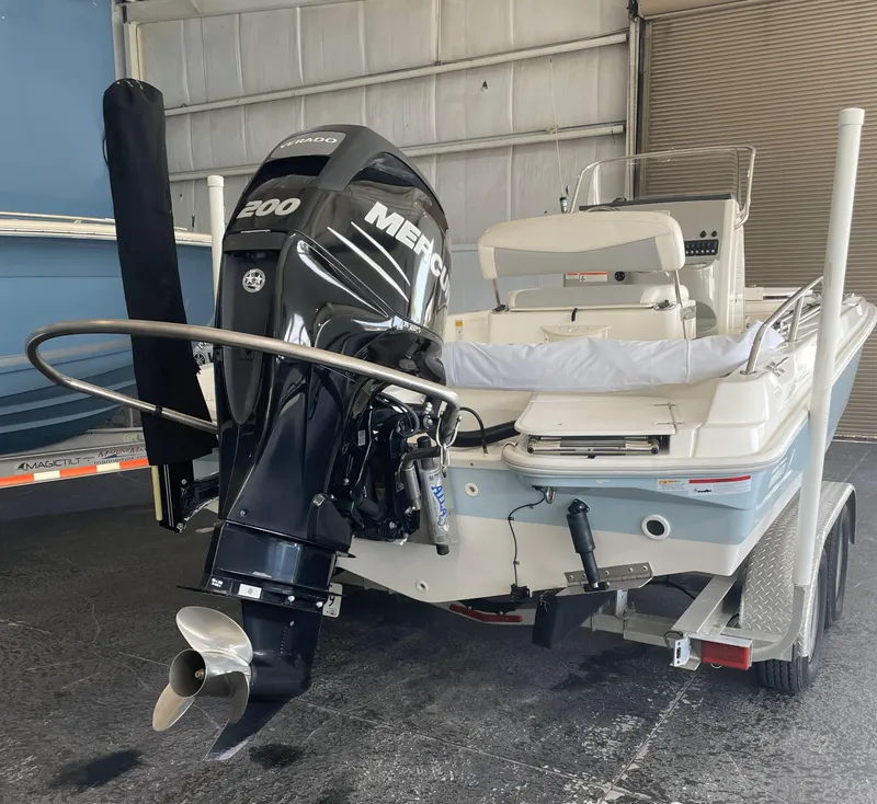 Slide: The Image of 2014 Boston Whaler 210 Dauntless boat with Mercury 200 engine in a garage. - 7