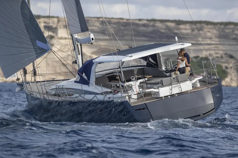 Slide: The Image of 2024 Jeanneau 65 sailing yacht navigating ocean waters, showcasing sleek design and modern features. - 2