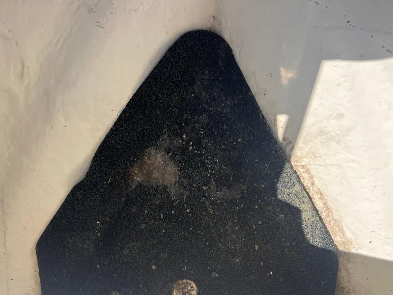 Slide: The Image of 2015 Triton 240 LTS boat interior with black non-slip flooring. - 11