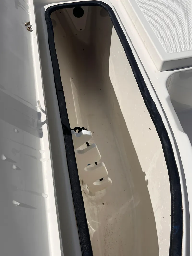 Slide: The Image of 2015 Triton 240 LTS boat storage compartment. - 13