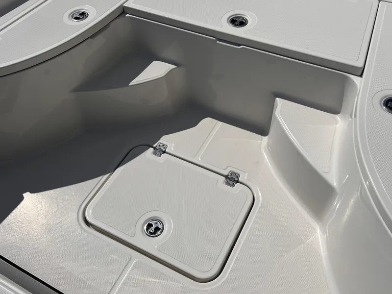 Slide: The Image of 2015 Triton 240 LTS boat deck with storage compartments. - 15