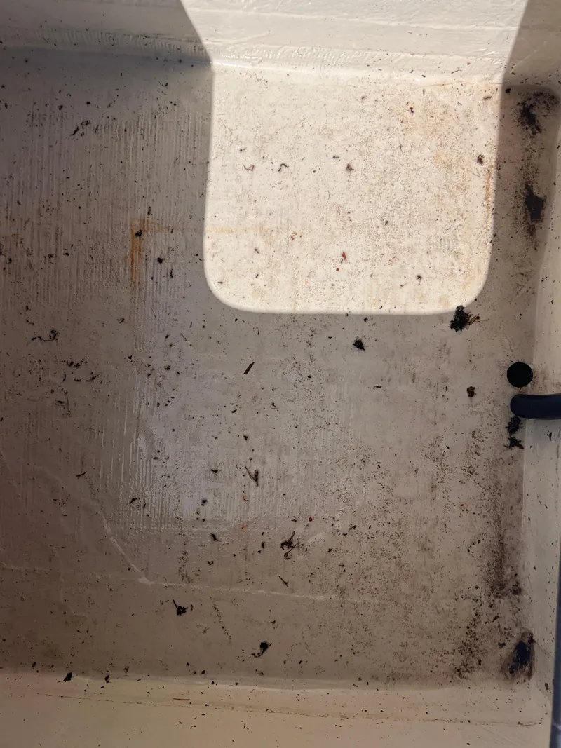 Slide: The Image of Dirty interior of a 2015 Triton 240 LTS boat compartment. - 16