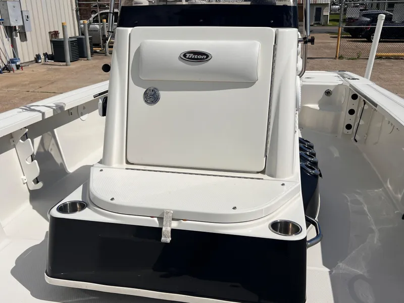 Slide: The Image of 2015 Triton 240 LTS boat interior with console and storage compartment. - 17