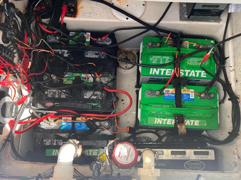 Slide: The Image of Battery compartment of a 2015 Triton 240 LTS boat with Interstate batteries. - 18