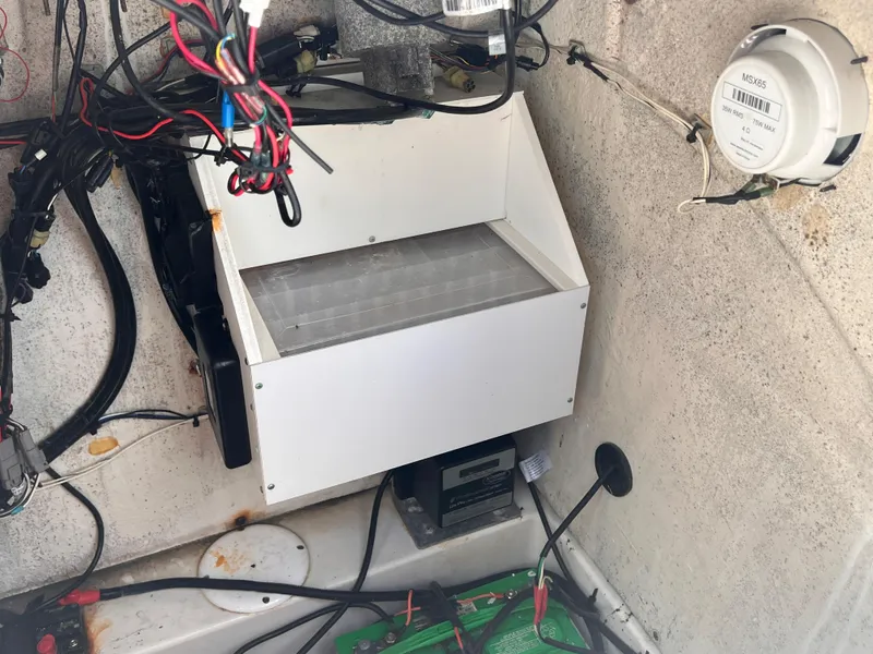 Slide: The Image of 2015 Triton 240 LTS boat interior wiring and battery compartment. - 20