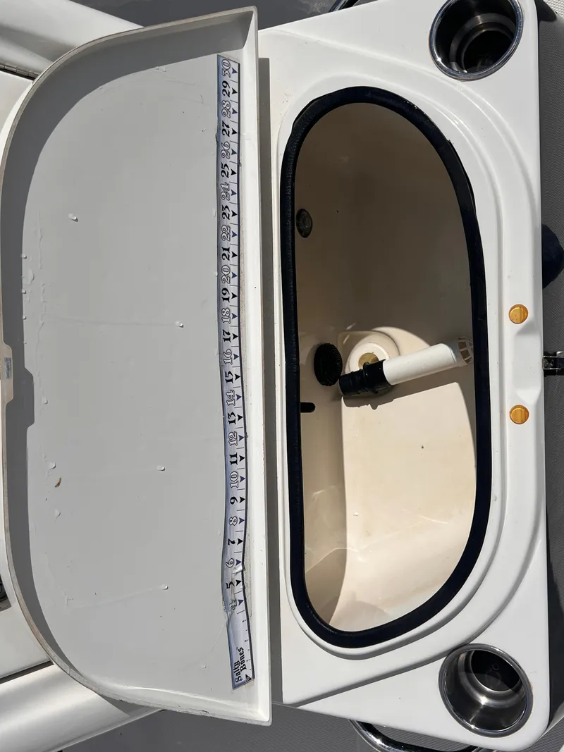 Slide: The Image of 2015 Triton 240 LTS livewell with measuring tape inside. - 21