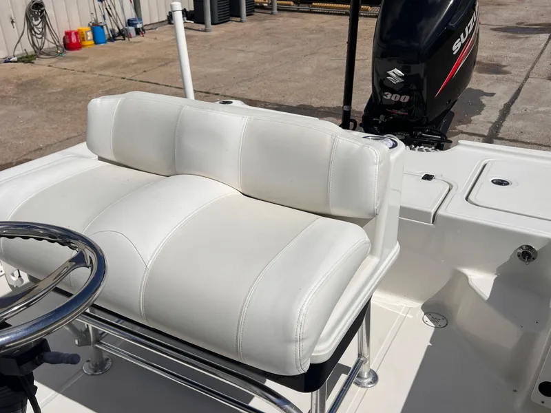 Slide: The Image of 2015 Triton 240 LTS boat with white cushioned seating and Suzuki 300 outboard motor. - 22