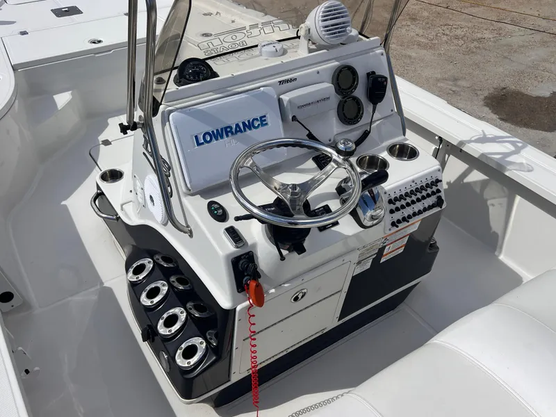 Slide: The Image of 2015 Triton 240 LTS boat console with Lowrance electronics and steering wheel. - 23