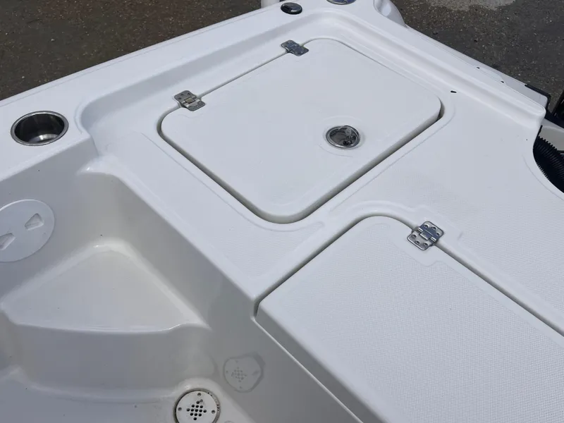Slide: The Image of 2015 Triton 240 LTS boat deck with storage compartments and cup holder. - 25