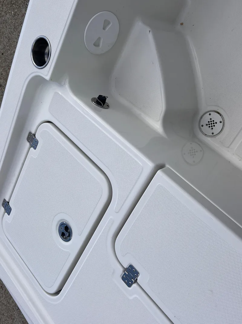 Slide: The Image of 2015 Triton 240 LTS boat deck with storage compartments and cup holder. - 27