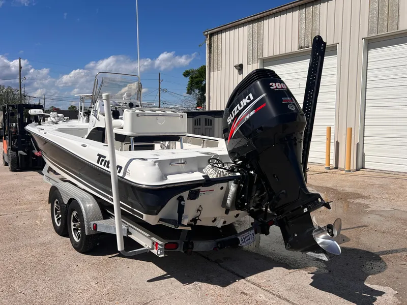 Slide: The Image of 2015 Triton 240 LTS boat with Suzuki 300 HP engine on trailer. - 3