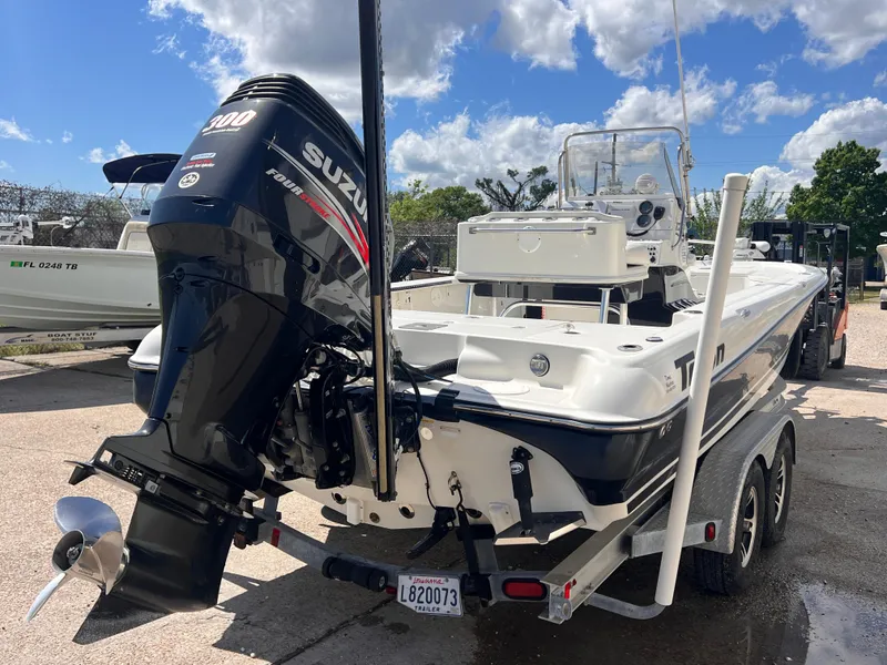 Slide: The Image of 2015 Triton 240 LTS boat with Suzuki 300 outboard motor on trailer. - 4