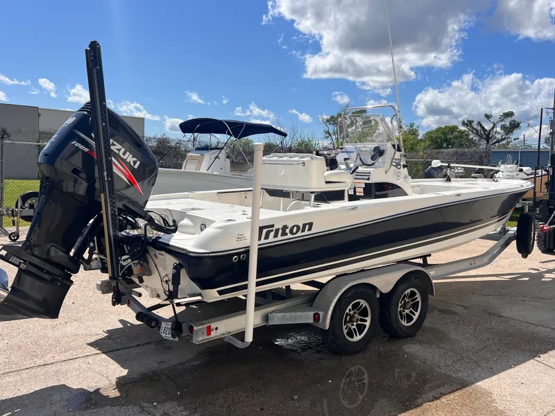 Slide: The Image of 2015 Triton 240 LTS boat on a trailer with Suzuki outboard motor. - 5