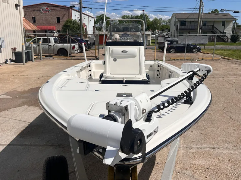 Slide: The Image of 2015 Triton 240 LTS boat with Minn Kota trolling motor in a parking lot. - 8