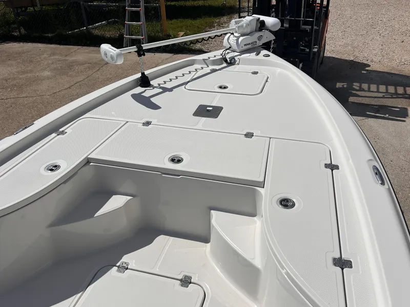 Slide: The Image of 2015 Triton 240 LTS boat deck with storage compartments and trolling motor. - 9