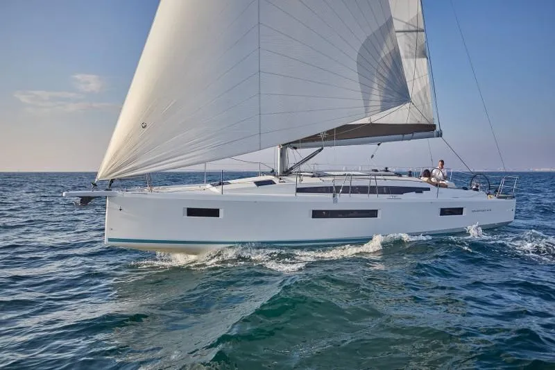 The Image of 2025 Jeanneau Sun Odyssey 410 sailing on open sea under clear skies. - 0