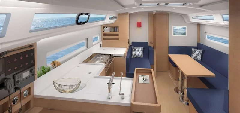 Slide: The Image of Interior of 2025 Jeanneau Sun Odyssey 410 yacht, featuring modern kitchen and seating area. - 10