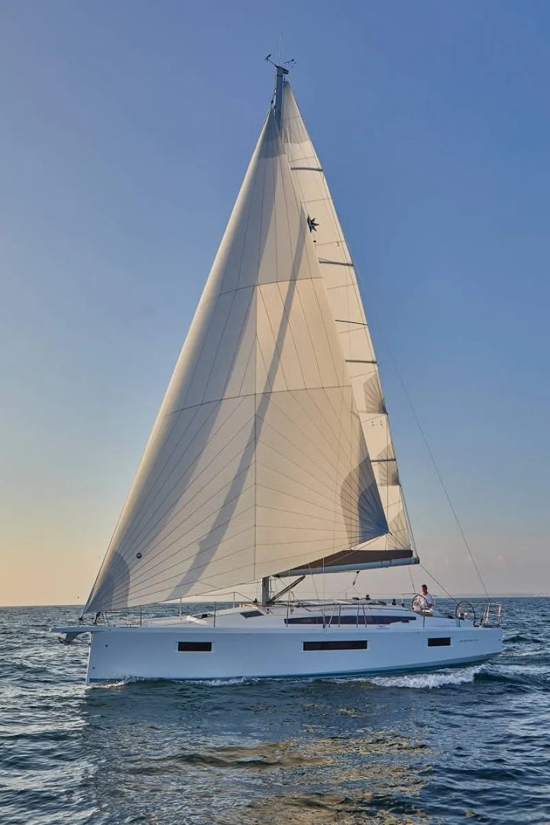 Slide: The Image of 2025 Jeanneau Sun Odyssey 410 sailing on open sea under clear blue sky. - 4