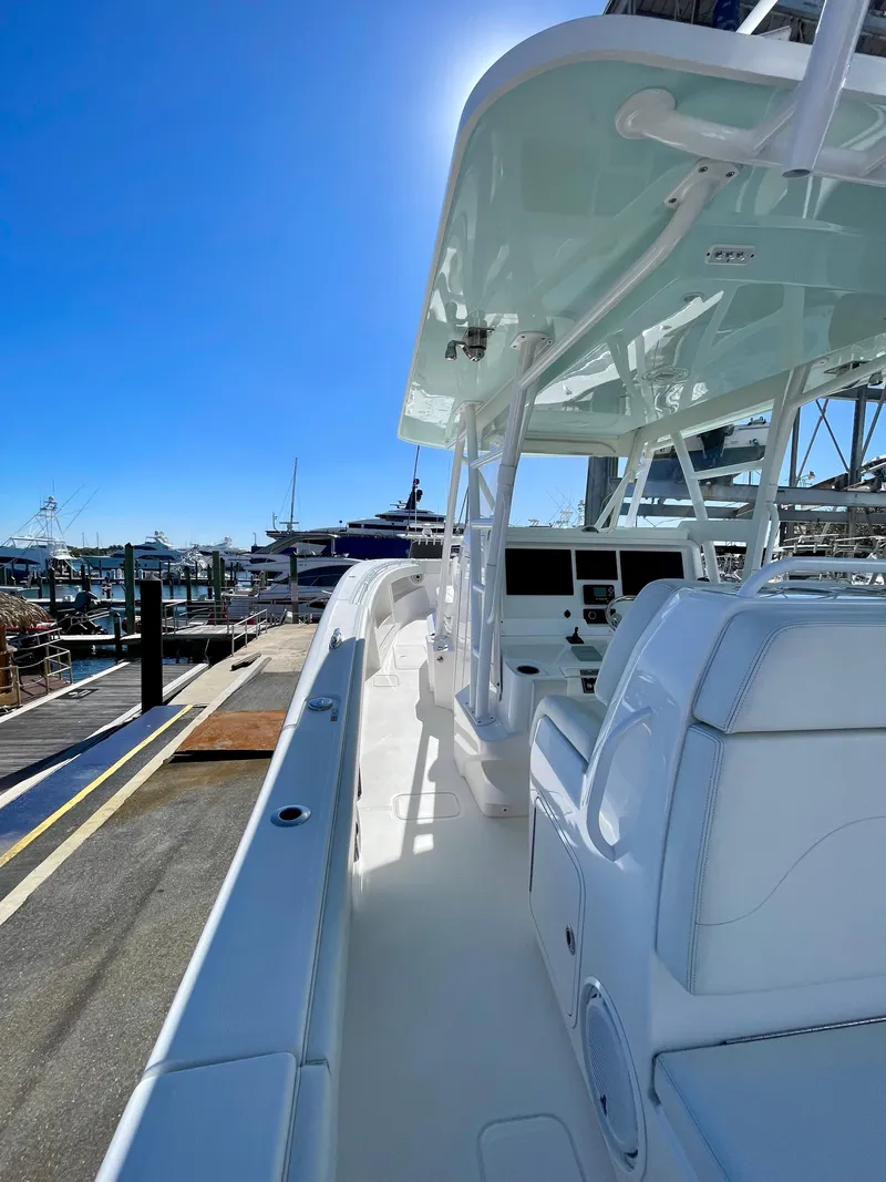 Slide: The Image of 2022 Invincible 39' Open Fisherman boat docked under clear blue sky. - 13