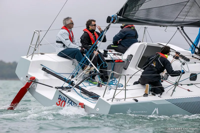 Slide: The Image of 2024 Jeanneau SUNFAST 30 ONE DESIGN sailboat with crew navigating in open water. - 5