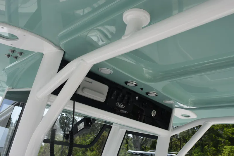 Slide: The Image of 2024 Sea Hunt Escape 25 boat interior with control panel and overhead structure. - 13