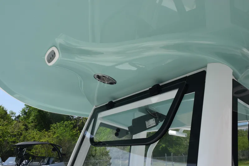 Slide: The Image of 2024 Sea Hunt Escape 25 boat canopy and window detail, showcasing sleek design and modern features. - 17