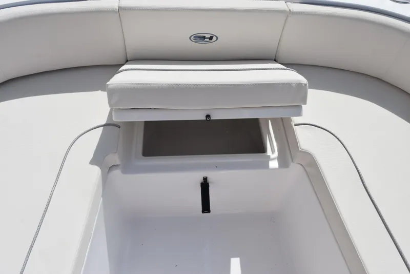 Slide: The Image of 2024 Sea Hunt Escape 25 boat with open storage compartment and cushioned seating. - 18