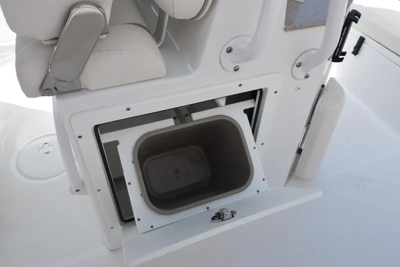Slide: The Image of 2024 Sea Hunt Escape 25 boat storage compartment with open hatch and seating. - 20