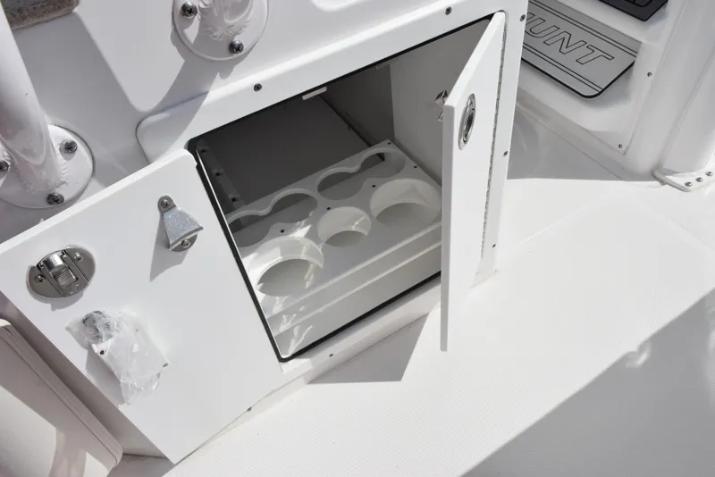 Slide: The Image of Open storage compartment on 2024 Sea Hunt Escape 25 boat, featuring cup holders. - 21