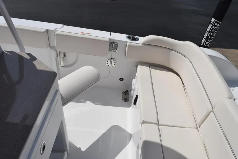 Slide: The Image of 2024 Sea Hunt Escape 25 boat interior with white cushioned seating. - 22