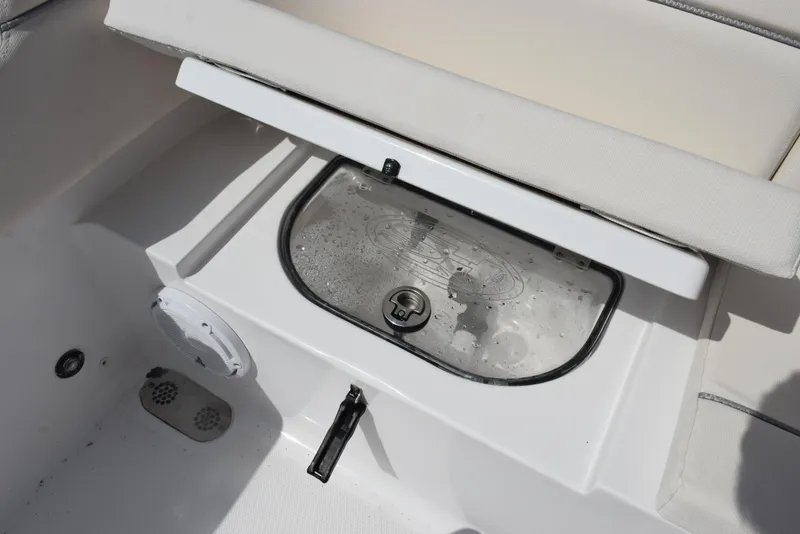 Slide: The Image of 2024 Sea Hunt Escape 25 boat storage compartment with transparent lid and latch. - 23