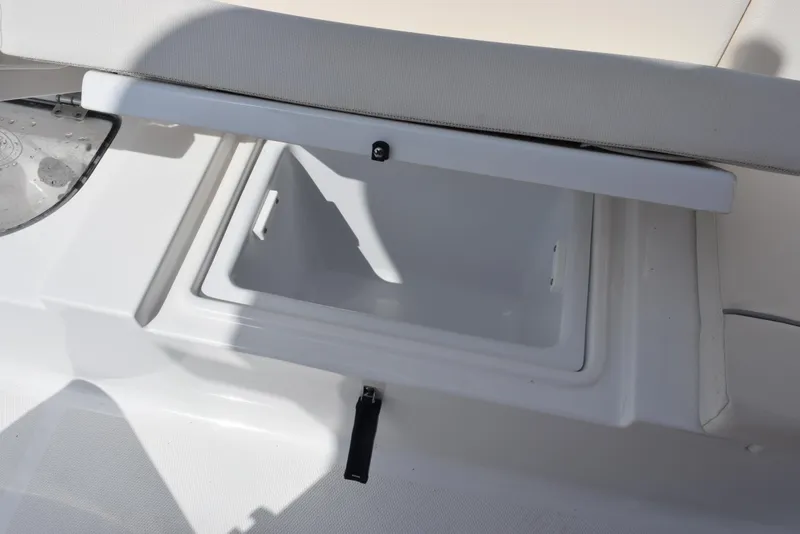Slide: The Image of 2024 Sea Hunt Escape 25 boat storage compartment with open lid, showcasing interior space. - 24