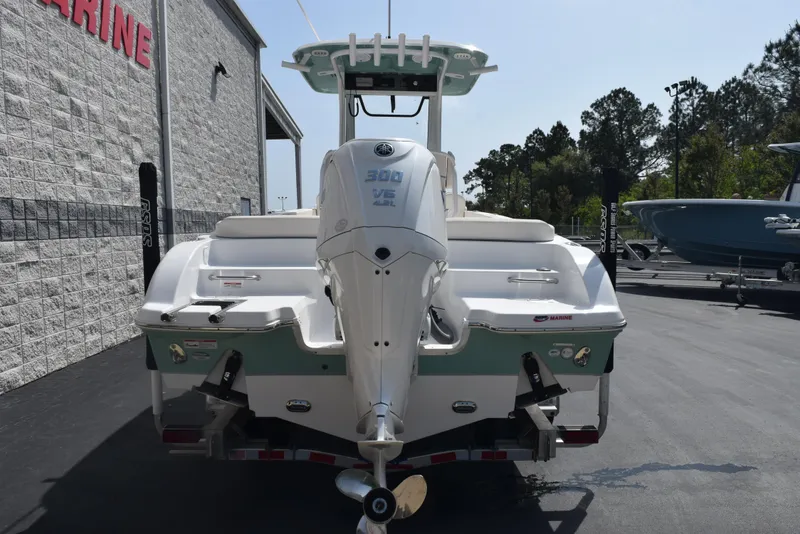 Slide: The Image of 2024 Sea Hunt Escape 25 boat with Yamaha 300 V6 engine, parked outdoors. - 5