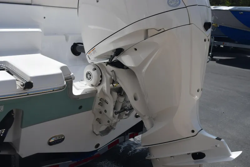Slide: The Image of 2024 Sea Hunt Escape 25 boat with powerful outboard motor, rear view. - 7