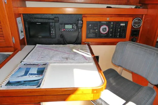 Slide: The Image of Navigation station of a 1991 Catalina 36 sailboat with charts and instruments. - 17