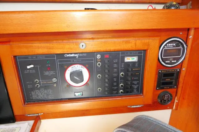 Slide: The Image of Control panel of a 1991 Catalina 36 sailboat with various gauges and switches. - 19