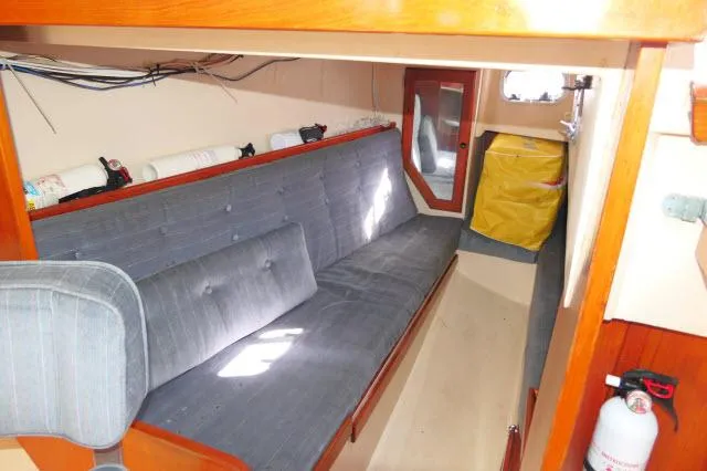 Slide: The Image of Interior of 1991 Catalina 36 sailboat with blue cushioned seating and wooden accents. - 20