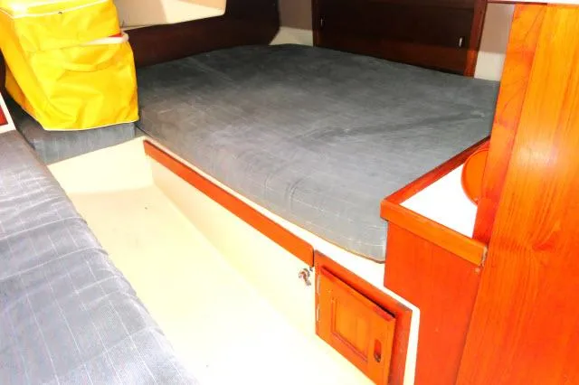 Slide: The Image of Interior cabin of a 1991 Catalina 36 sailboat with grey cushions and wooden cabinetry. - 21