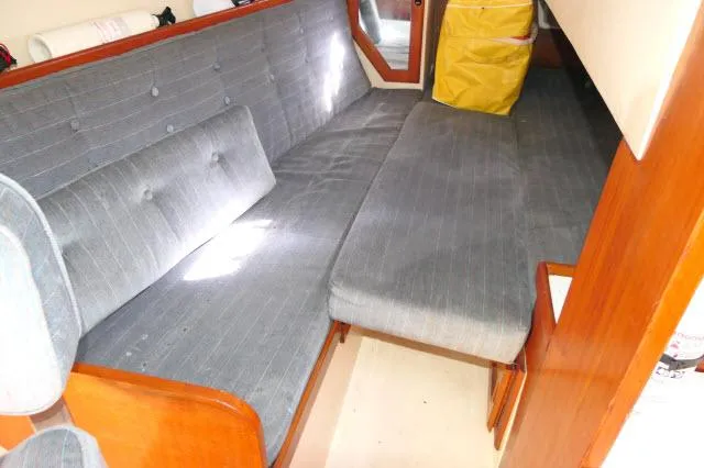 Slide: The Image of Interior of 1991 Catalina 36 sailboat with gray upholstered seating. - 22