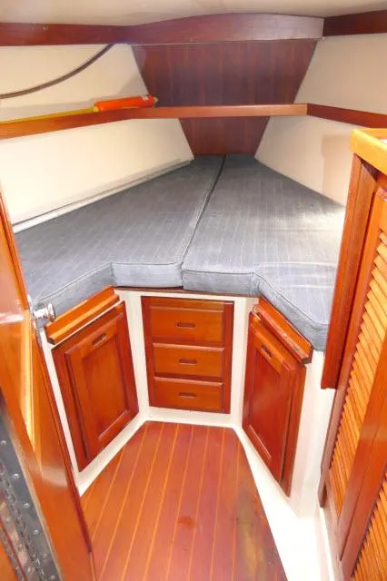 Slide: The Image of 1991 Catalina 36 sailboat interior with wooden cabinets and cushioned V-berth. - 24