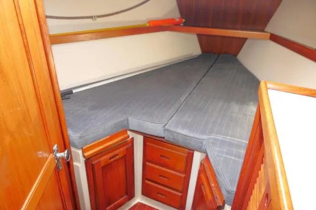 Slide: The Image of 1991 Catalina 36 sailboat interior cabin with V-berth and wooden storage cabinets. - 25