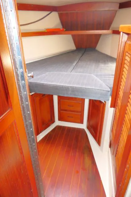 Slide: The Image of 1991 Catalina 36 sailboat interior cabin with wooden finish and V-berth. - 26