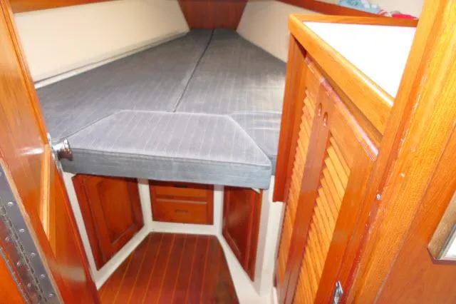 Slide: The Image of 1991 Catalina 36 sailboat interior cabin with wooden finishes and a V-berth. - 27