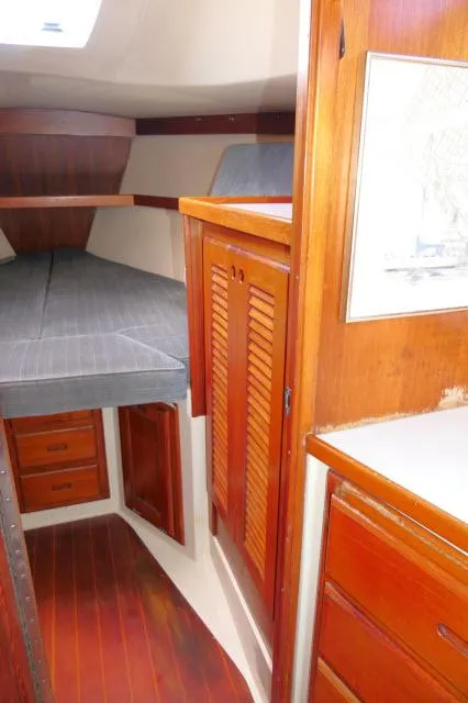 Slide: The Image of Interior cabin of a 1991 Catalina 36 sailboat with wooden cabinetry and a V-berth. - 29