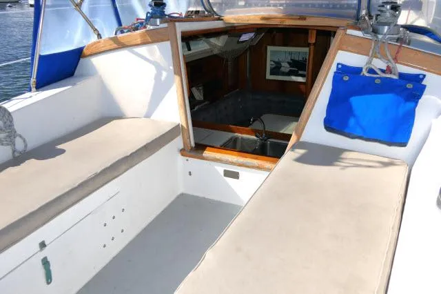 Slide: The Image of Cockpit of a 1991 Catalina 36 sailboat with cushioned seating and cabin entrance. - 35